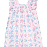 BISBY girl woven dress in a white/pink/red/blue fun pattern. Dress features a square neckline with a light pink ribbon trim, three button closure at back, angel sleeve detail, and light pink pom poms along edge of sleeves for an elevated look.