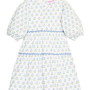 BISBY girl woven white dress in blue/green floral print. Dress features three button closure along back, elastic cuffs at sleeve, and blue ric rac detail across tiers of dress for an elevated look.