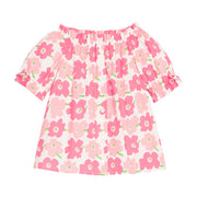 BISBY girl woven top in a salmon pink and a red floral print. Top features an elastic neckline, elastic cuffs at sleeves, and faux bow ties at ends of sleeves for an elevated look. 