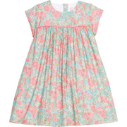 Girls woven dress in a pink/teal/green floral print that features a four button closure along back of dress and a pink trim across the bust and end of sleeves for an elevated look. 
