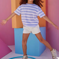 white jean shorts for girls with striped purple and white boxy t shirt 