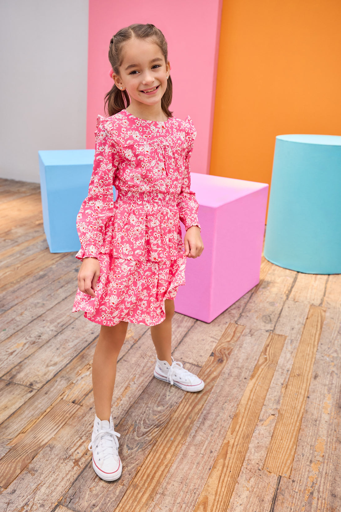 Model can be seen wearing pink/white/red floral woven dress that features an elastic ruched waistband and a two-tiered skirt detail to elevate the dress. 