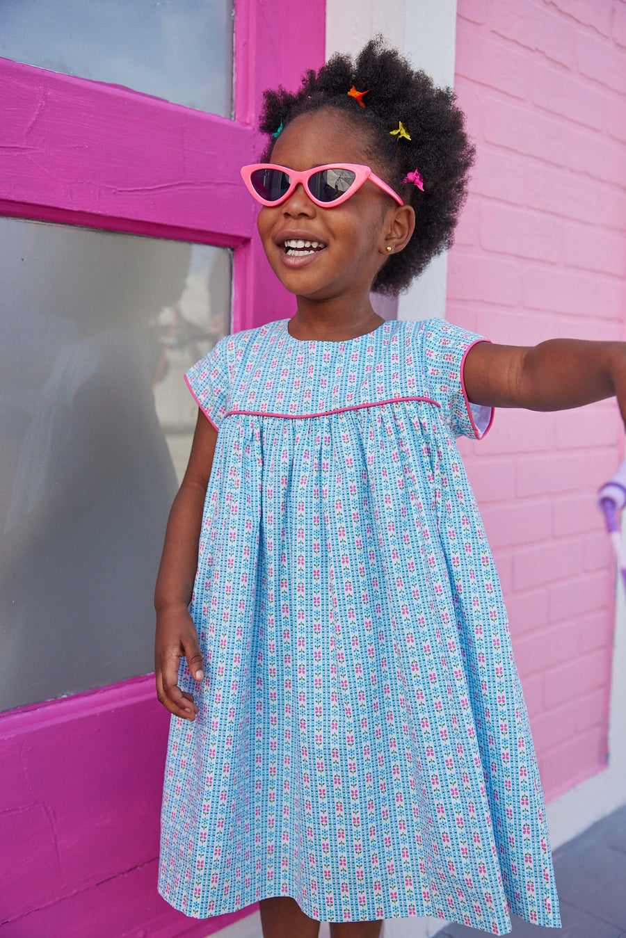 Girl dress with blue and pink floral print, with hot pink trim across bust and sleeves