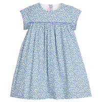 Girls woven short sleeve dress in a blue floral pattern that features button closure at back of neckline. Dress also features a blue trim across bust and end of sleeves for an elevated look. 