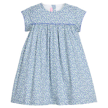 Girls woven short sleeve dress in a blue floral pattern that features button closure at back of neckline. Dress also features a blue trim across bust and end of sleeves for an elevated look. 