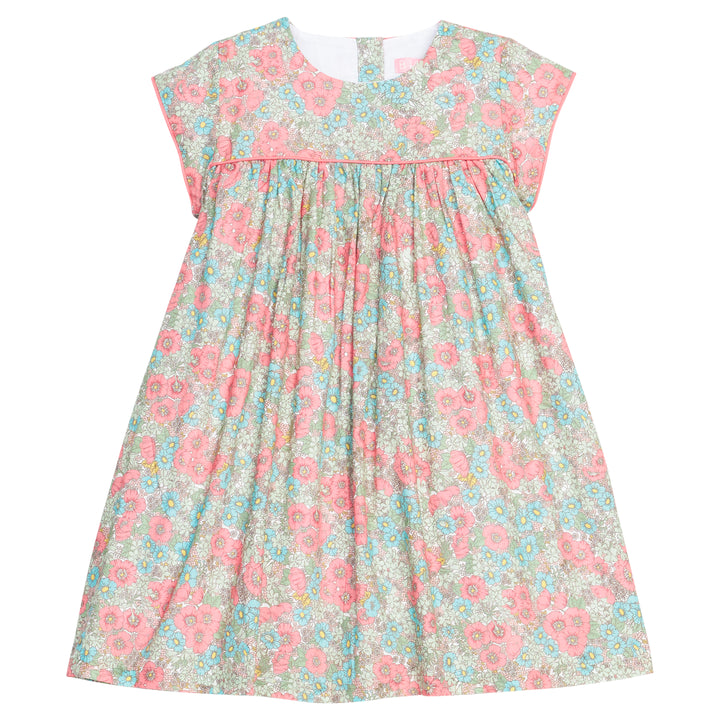 Girls woven dress in a pink/teal/green floral print that features a four button closure along back of dress and a pink trim across the bust and end of sleeves for an elevated look. 
