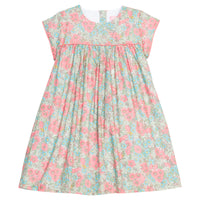 Girls woven dress in a pink/teal/green floral print that features a four button closure along back of dress and a pink trim across the bust and end of sleeves for an elevated look. 