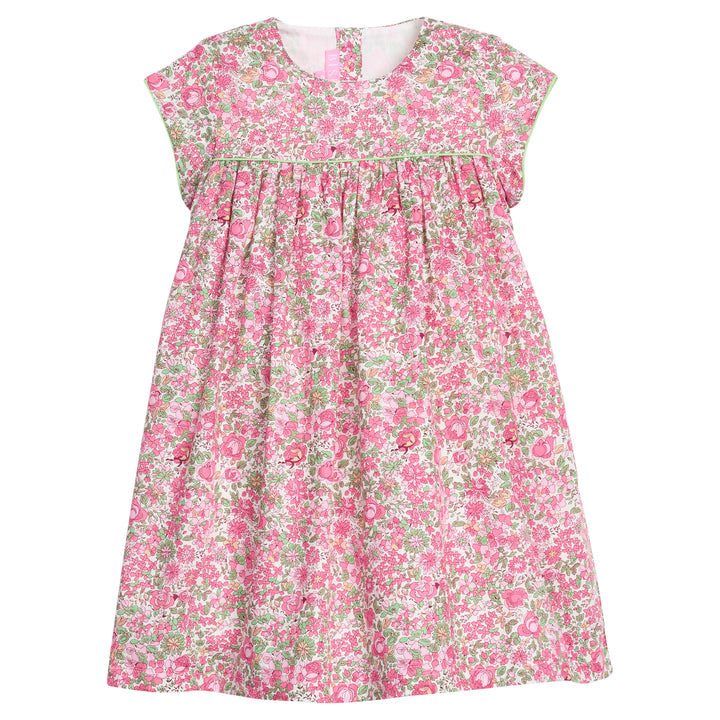 Girls pink and green floral dress with green piping along bust and trim of sleeves, that also features a four button closure along back of neckline. 