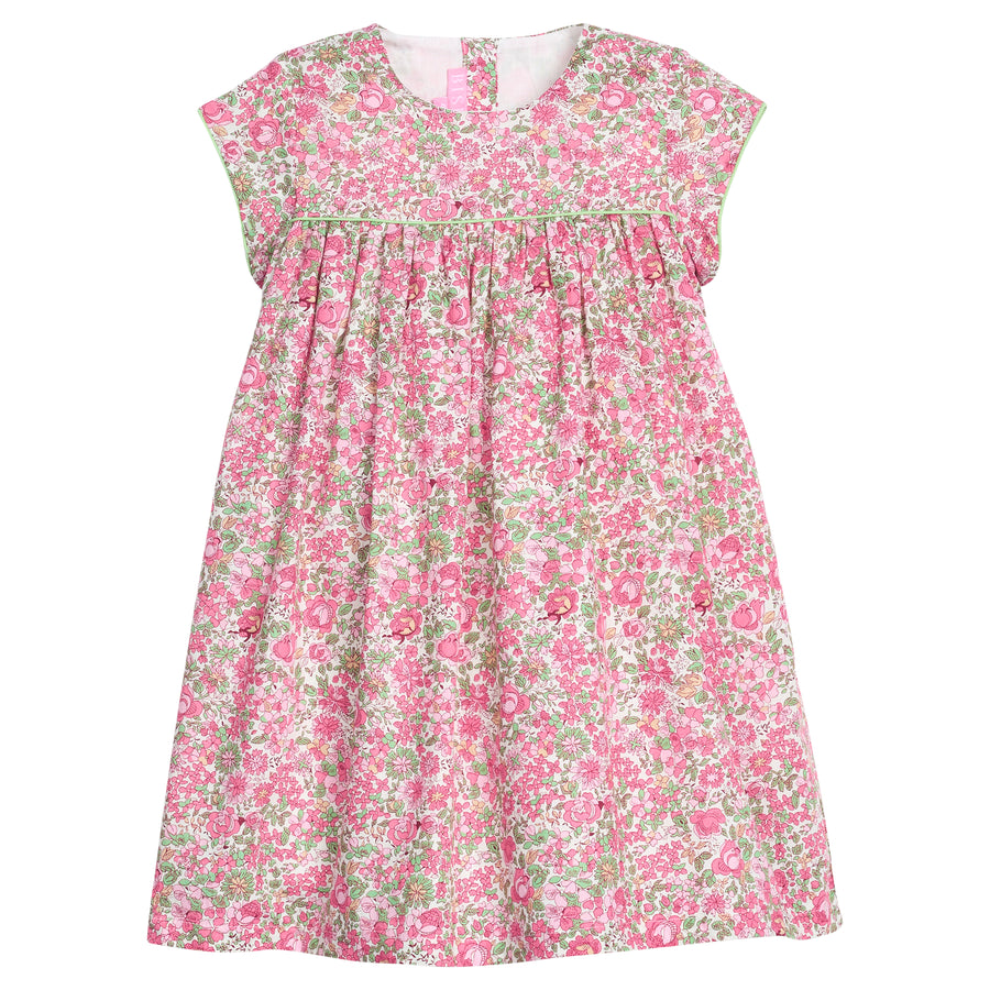 Girls pink and green floral dress with green piping along bust and trim of sleeves, that also features a four button closure along back of neckline. 