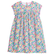 Girl dress with colorful floral print, with light pink trim across bust area and sleeves