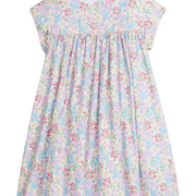 Girls/Tween woven short sleeve dress in a pale yellow with pink/red/blue/green floral print. Dress features button closure at back and a light pink trim detail at bust which adds some fun volume that also continues onto the trim of the sleeves as well.