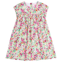 Girls dress featuring our Magenta Floral. Dress has a light pink trim that goes along the ends of the short sleeves and across the bust of the dress. Dress also has buttons along back making it easy to get in and out of-BISBY