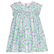 BISBY girl woven dress in an aqua/purple/blue floral print. Dress features three button closure at back and matching purple trim across bust and end of sleeves for a completed look. 