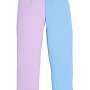 Pair of girls quilted pants in purple and blue on a white background featuring a drawstring waist.