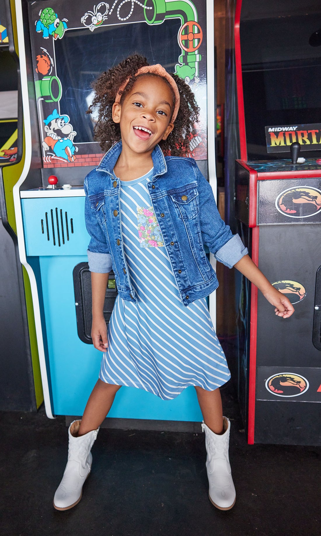 Little girl seen wearing our Everyday Dress in French Blue Stripes/ Merion Floral pocket-paired with our jean jacket--BISBY girls