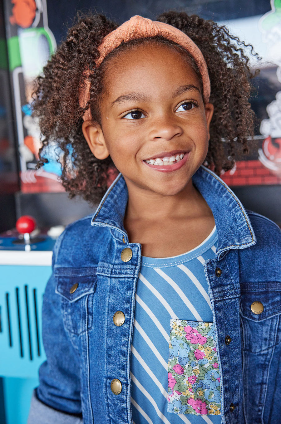 Little girl seen wearing our Everyday Dress in French Blue Stripes/ Merion Floral pocket-paired with our jean jacket--BISBY girls