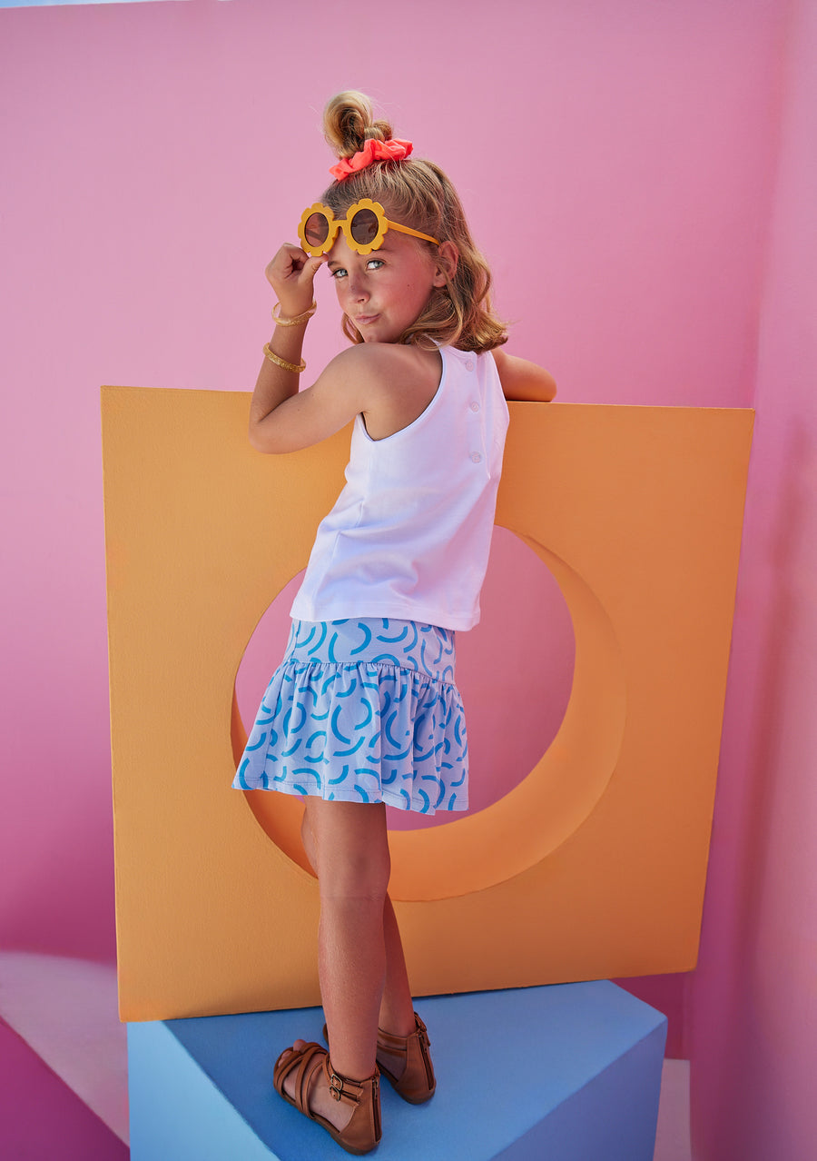 BISBY girl in our Sally Skort in our fun Blue Ripple pattern which has built in shorts and stretchy waistband. Pair it back with our halter top in white for a complete look.