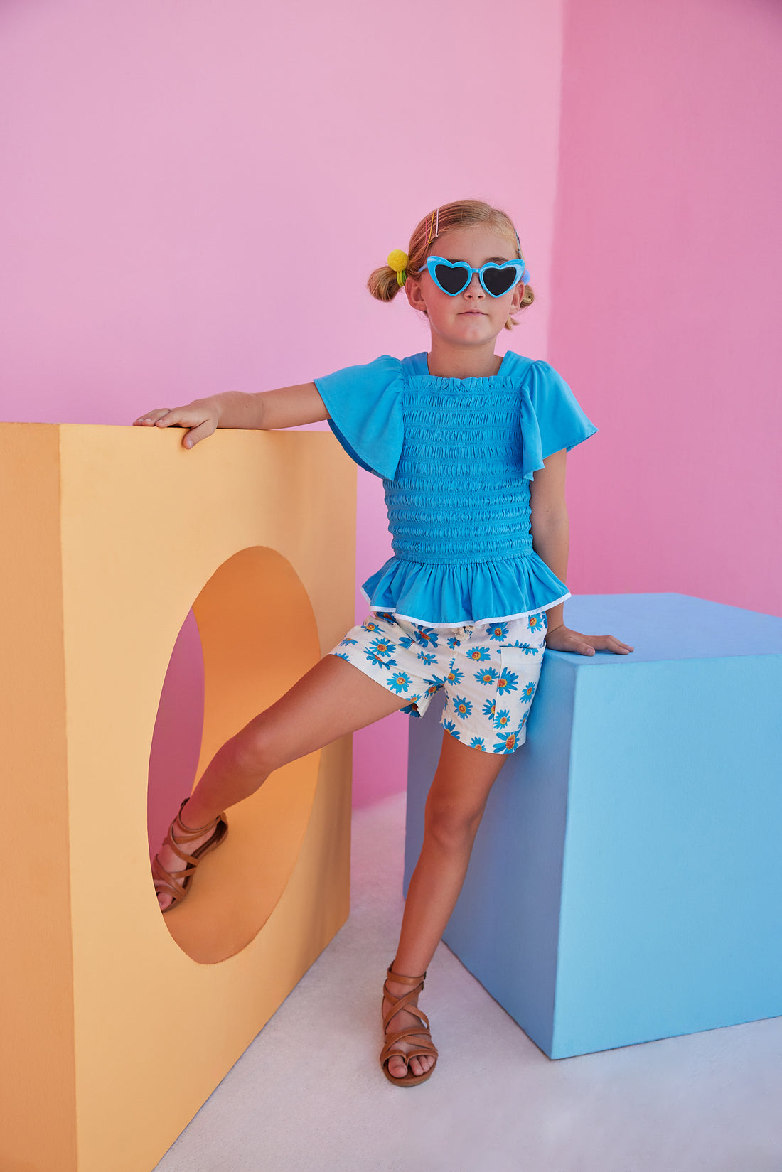 BISBY girl wearing our new Patch Pocket Shorts in our Fenwick Blue floral pattern. These shorts have pockets in the front and fixed ties with an elastic waistband. They pair perfectly back with our India Top in Blue or even our Michaela top in Fenwick Blue for a completed look.