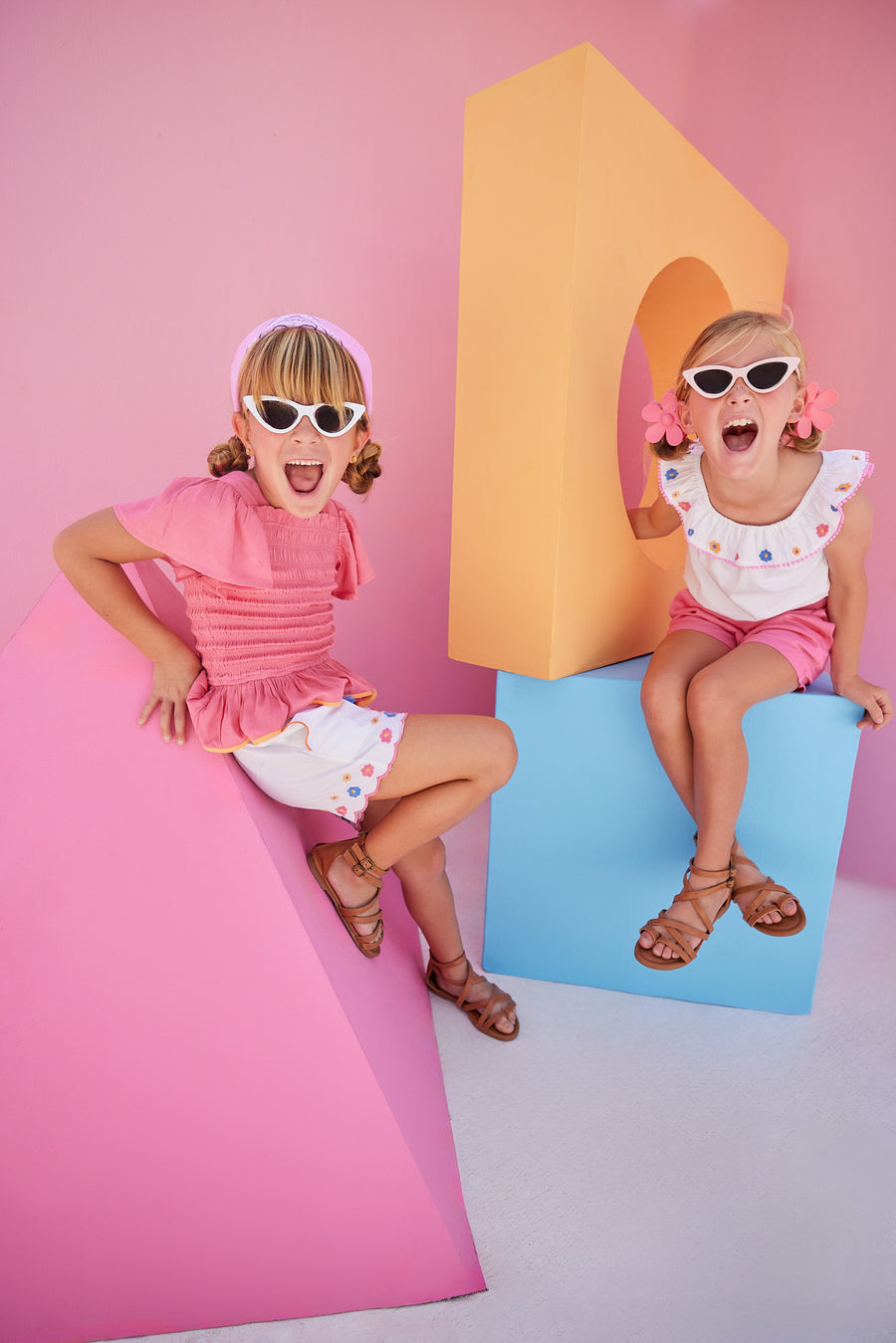 Hot pink ruched smocked top for girls and tweens with orange trim which pair perfectly back with our Richmond Shorts in our Flower Market Embroidery.