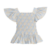 Girls/Tween woven top that has a ruching feature across middle of top. Top is made of yellow and white flowers printed on a light blue background and also features angel sleeves to complete the look. 