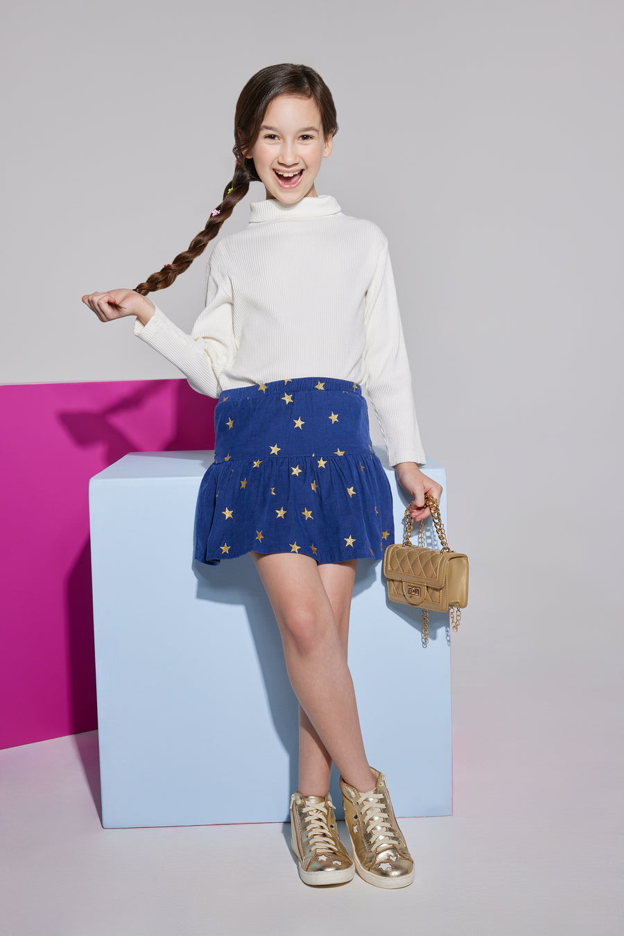 Girls/Tween ribbed turtleneck in ivory which is made of a super soft knit ribbed material. The navy skort with gold stars is a perfect piece to pair with the turtleneck and has details like built in shorts and an elastic waistband for a relaxed comfy fit.
