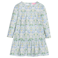 Girls/tween woven long sleeve dress in a blue/green/white floral print. Dress features two tiers and pleating detail and button closure at back for easy put on/take off access.