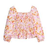 Girls/tween pink/orange floral patterned blouse with long sleeves that features elastic ruching across body of shirt and elastic cuffs for a secure but relaxed fit. 