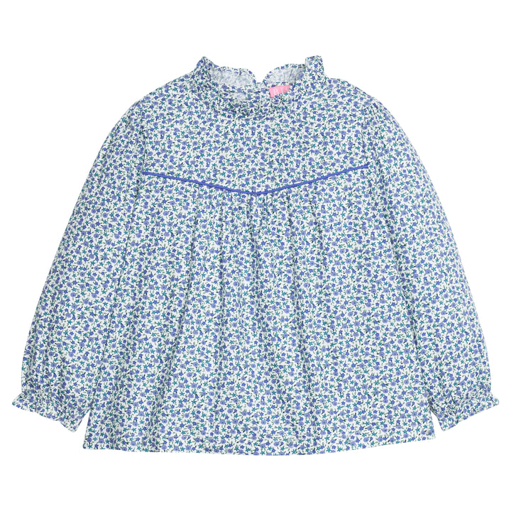 Girls/tween woven long sleeve top in a blue floral print that features a high neck ruffle neckline, button closure at back,  and a blue trim detail across the bust to elevate the look. 