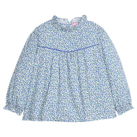 Girls/tween woven long sleeve top in a blue floral print that features a high neck ruffle neckline, button closure at back,  and a blue trim detail across the bust to elevate the look. 