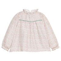 Girls/tween woven long sleeve top in a green and red floral print that features a high neck ruffle neckline, button closure at back,  and a green trim detail across the bust to elevate the look. 