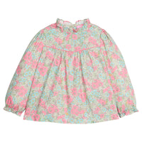 Girls/tween woven long sleeve top in a pink/green/teal floral print that features a high neck ruffle neckline, button closure at back,  and a pink trim detail across the bust to elevate the look. 