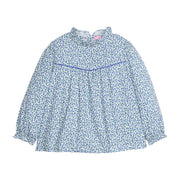Girls/tween woven long sleeve top in a blue floral print that features a high neck ruffle neckline, button closure at back,  and a blue trim detail across the bust to elevate the look. 