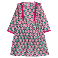 Girls/tween woven 3/4 length sleeve dress in a green/pink floral pattern. Dress features button closures at back, ruffle detail along outside of bust, and a cranberry velvet trim detail along ruffles and sleeve ends to elevate the look. 
