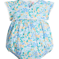 Baby girl woven bubble with ruffle/angel sleeves and slight v-neck neckline and multi-color blue and yellow flowers printed across the body. The bust-line and sleeves are also lined with white pom poms and there are button closures along the stride. 