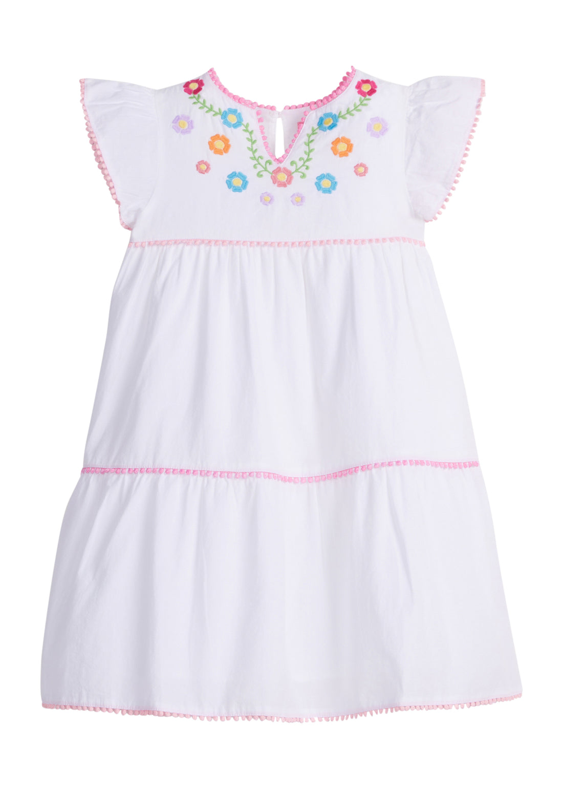 Girls/Tween woven white tiered dress with multi-color floral embroidery detail on chest/along the v-neck neckline. Dress also features light pink pom poms along sleeve and first and bottom tiers of dress. A row of bubblegum pink pom poms is seen along the second tier of dress and around neckline. There is also a button closure at back of neckline for a secure fit