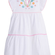 Girls/Tween woven white tiered dress with multi-color floral embroidery detail on chest/along the v-neck neckline. Dress also features light pink pom poms along sleeve and first and bottom tiers of dress. A row of bubblegum pink pom poms is seen along the second tier of dress and around neckline. There is also a button closure at back of neckline for a secure fit