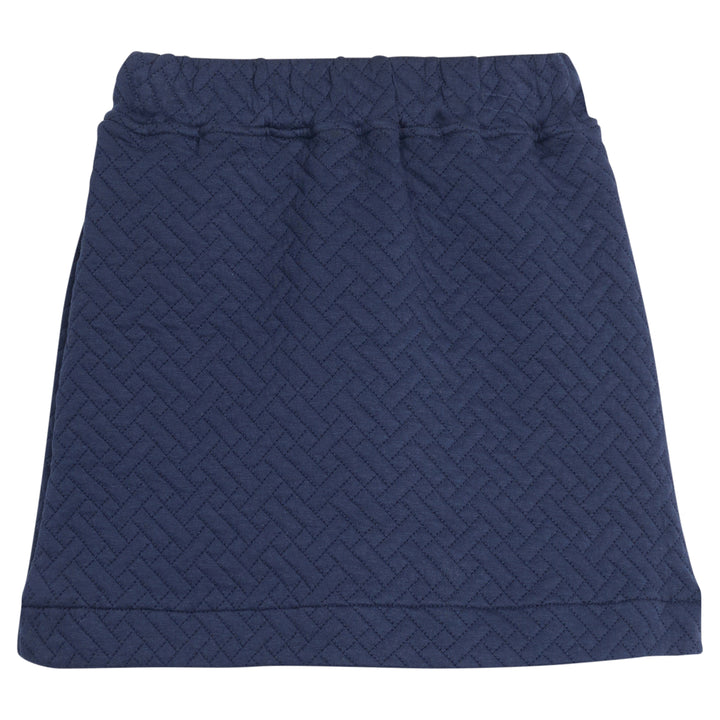 Girls/tween quilted mini skort in navy that features an elastic waistband and built in shorts for a secure but relaxed fit. 