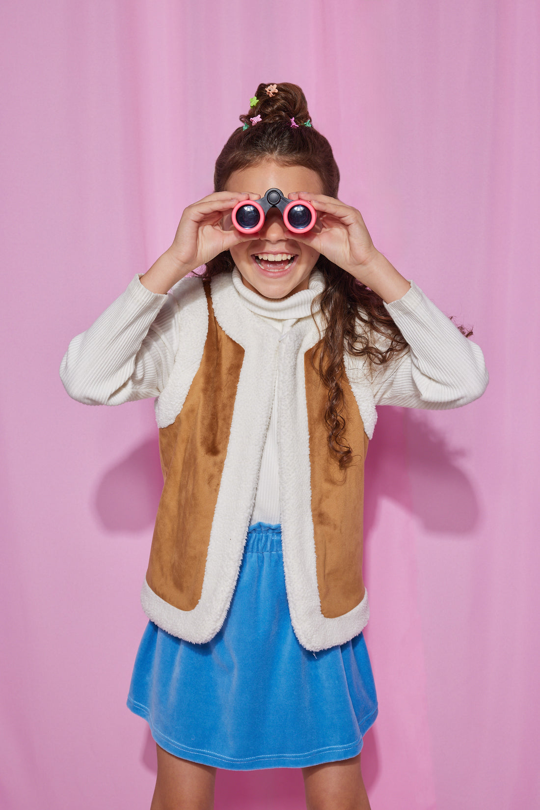 Girls/Tween velour skirt in a French blue color. Skirt features an elastic waistband and made of a super soft stretchy material for ultimate comfort. Model can be seen wearing a ribbed turtleneck in ivory underneath a reversible sherpa/suede vest to complete the look.
