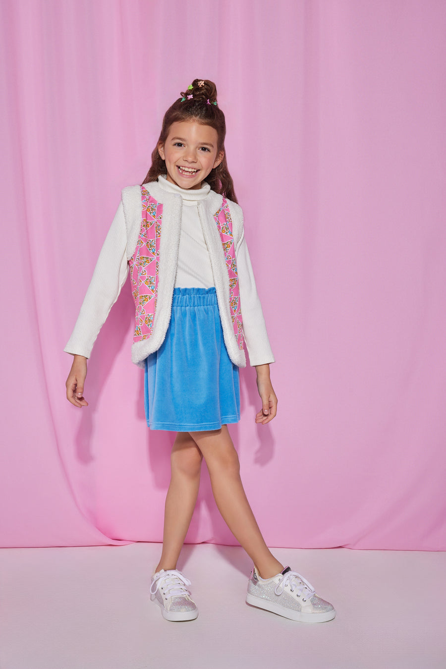Girls/Tween velour skirt in a French blue color. Skirt features an elastic waistband and made of a super soft stretchy material for ultimate comfort. Model can be seen wearing a ribbed turtleneck in ivory underneath a reversible sherpa/suede vest to complete the look.