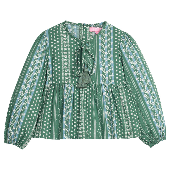 Girls/tween woven long sleeve top in a green/blue floral print. Top features tie tassel detail at neckline, elastic cuffs at sleeves, and button closures at back.