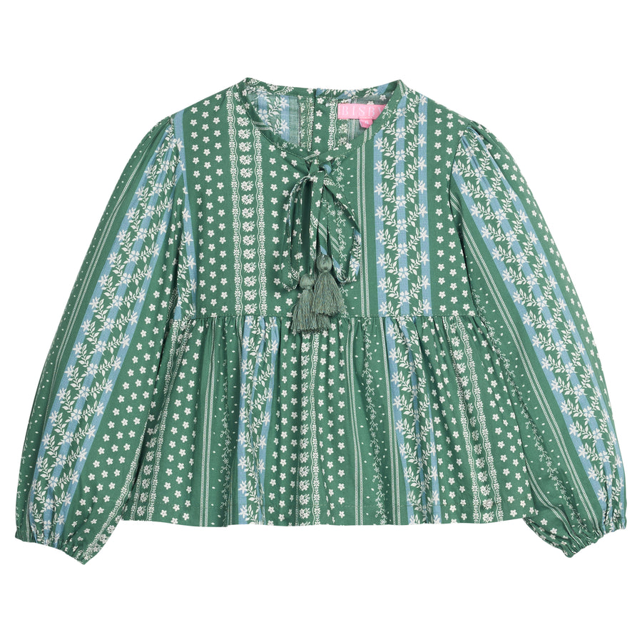 Girls/tween woven long sleeve top in a green/blue floral print. Top features tie tassel detail at neckline, elastic cuffs at sleeves, and button closures at back.