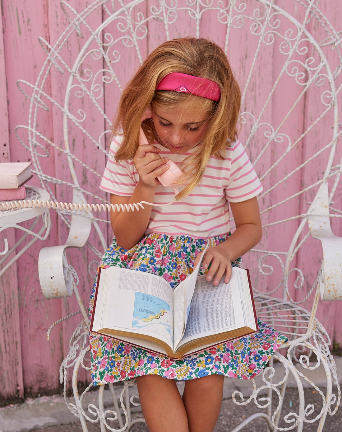 BISBY girl in our Rosie Dress in Tulip Garden. Top half of dress is a knit white and pink stripe and bottom half has a beautiful woven colorful floral.