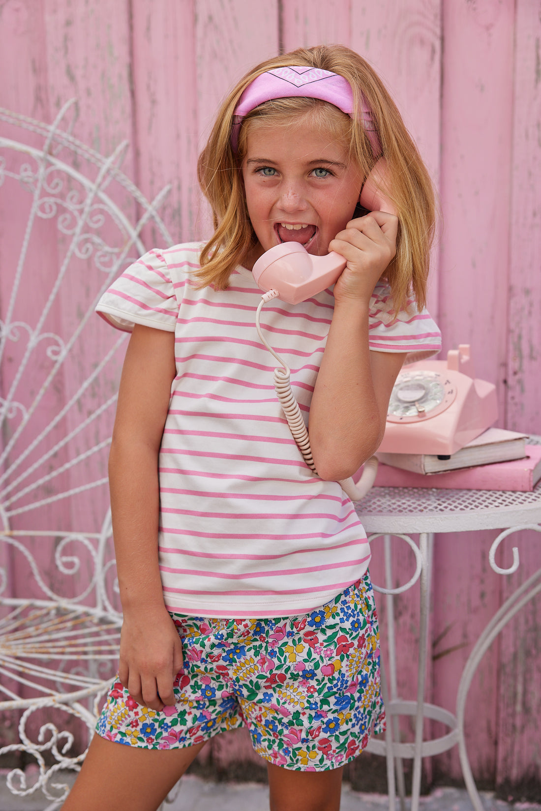 BISBY girl in our Rosie Short Set. The top is an angel sleeve knit tee with pink and white stripes paired with our Tulip Garden print shorts.