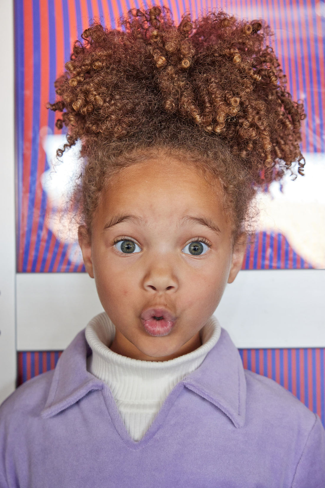 Little girl can be seen wearing our Lilac Polo pullover layered with our Cream colored essential turtleneck underneath--BISBY girl