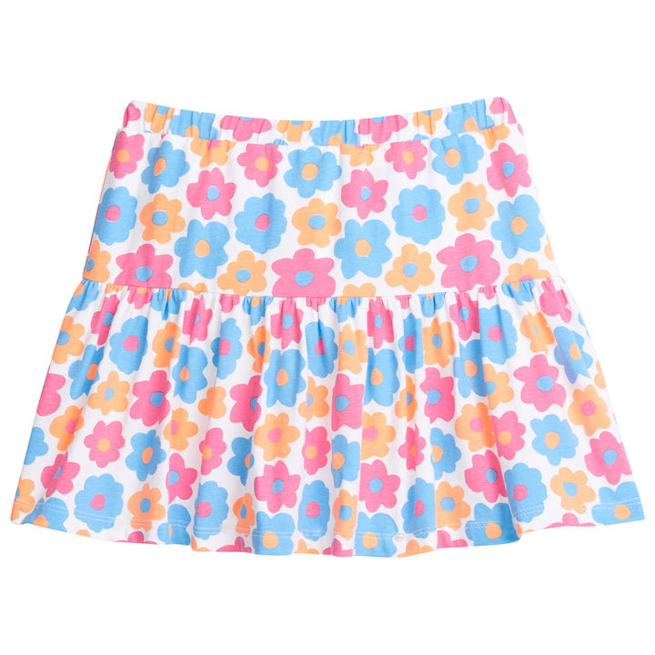 Girl/tween knit skort, with built in shorts, elastic waistband, and slight ruching along bottom. Skort is a colorful floral print with orange, pink, and blue flowers printed across it.
