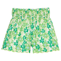 BISBY girl woven shorts with a blue and green floral print. Shorts feature a smocked waistband, pockets, and a scalloped bottom hem for an elevated look. 