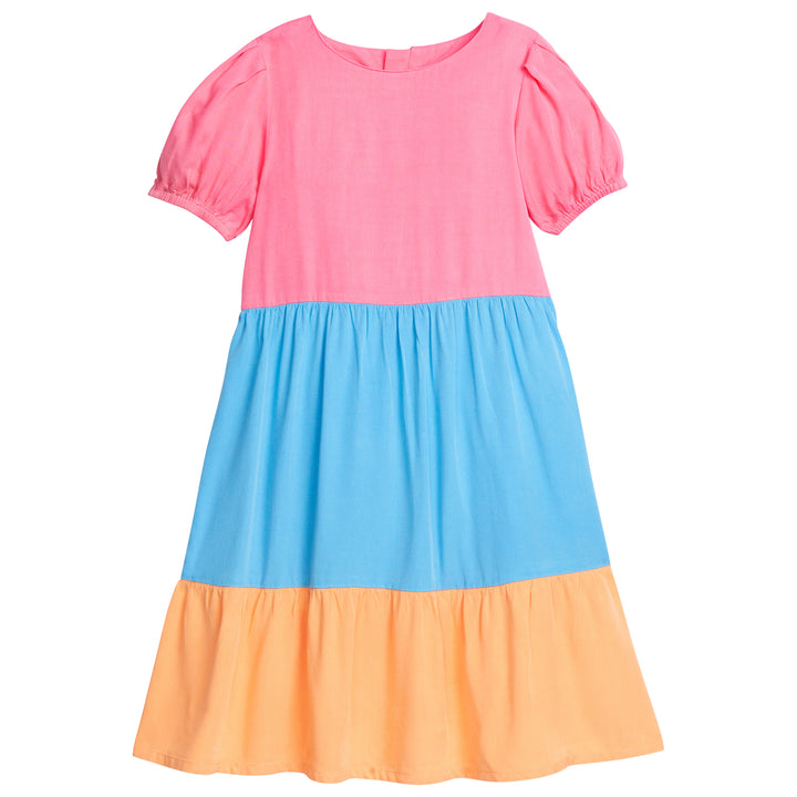 Girl color block rayon material dress that has elastic around sleeves and with the top section of dress in pink, middle section in blue, and bottom section in orange.