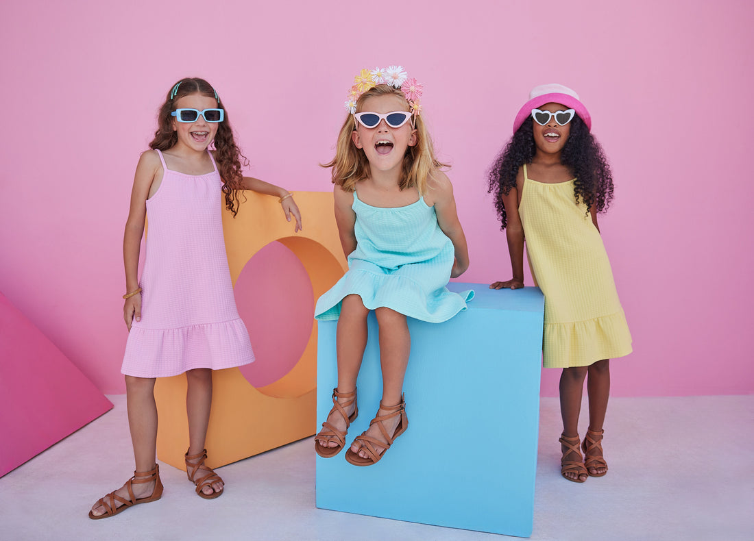 Girl/tween dress with thin stretchy straps and a waffle knit pattern, all in a solid pink color. 