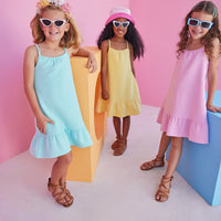 Girl/tween dress with thin stretchy straps and a waffle knit pattern, all in a pink solid color. 