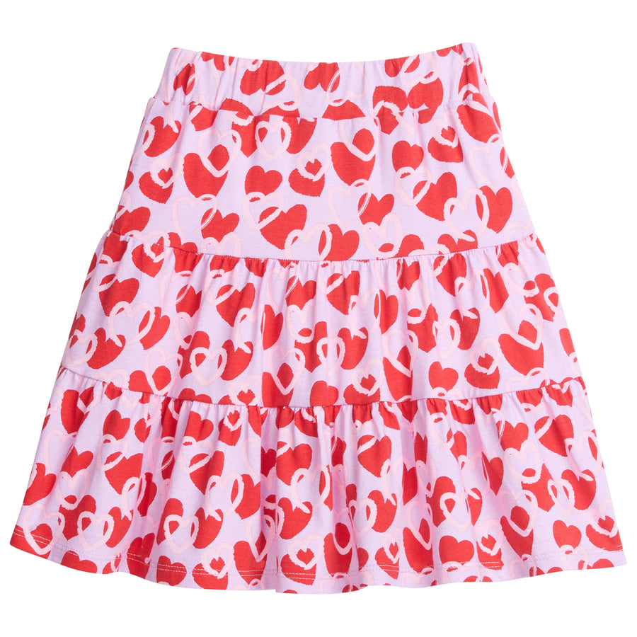 Knit skort that has built in shorts and elastic waistband with lilac background with light pink and red hearts printed across it.